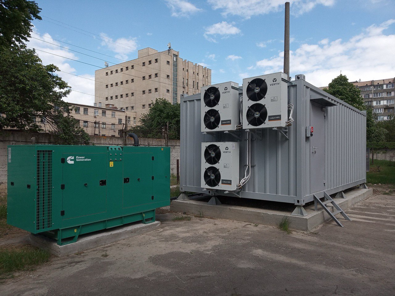 Containerized modular data center with Vertiv Liebert cooling units and Cummins diesel generator deployed on concrete pad for traffic monitoring infrastructure